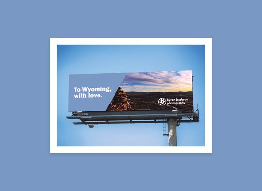 Billboard mockup that showcases a landscape and Byron’s logo. Reads: “To Wyoming, with love.”