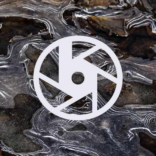 The Byron Jacobson Photography logo placed on a macro view of the rocky bed of a frozen river. Texture FTW!