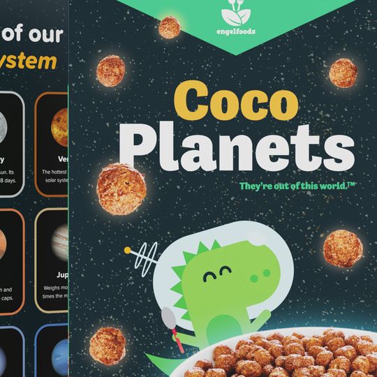 Two cereal box mockups showcasing designs on the front and back. The front features a happy green dinosaur in outer space. The back features an array of planets in our solar system.