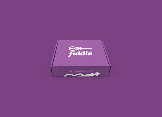 A purple box mockup that shows the logo along with the tagline, “Can you taste the music?”