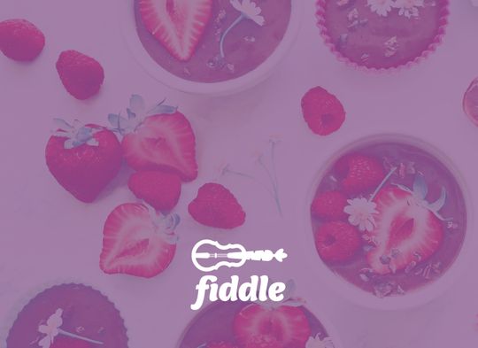 The logo placed on bowls of chocolate pudding with fresh strawberries and raspberries